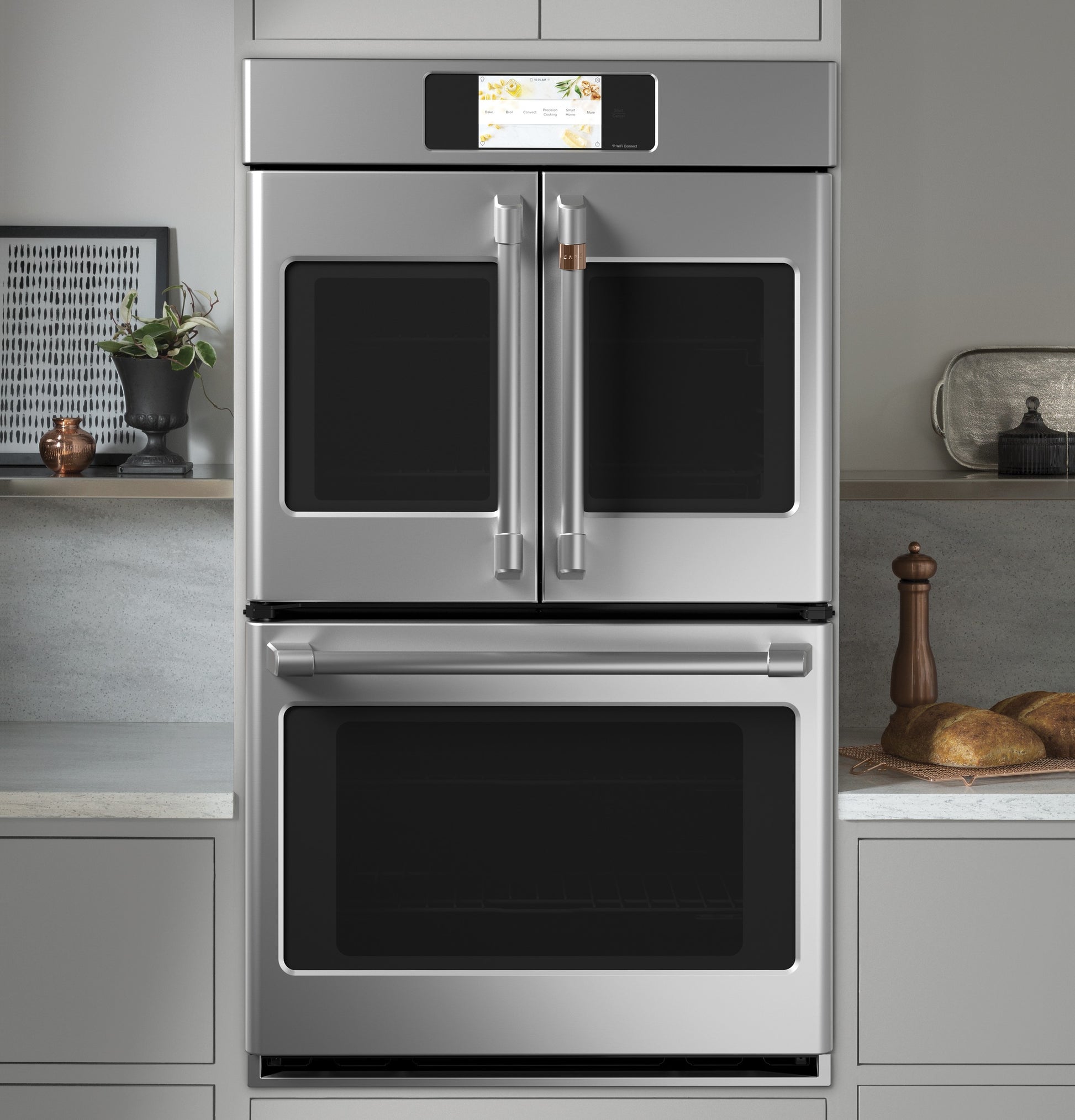 Stainless steel double wall oven with French doors and digital control panel in modern kitchen setting