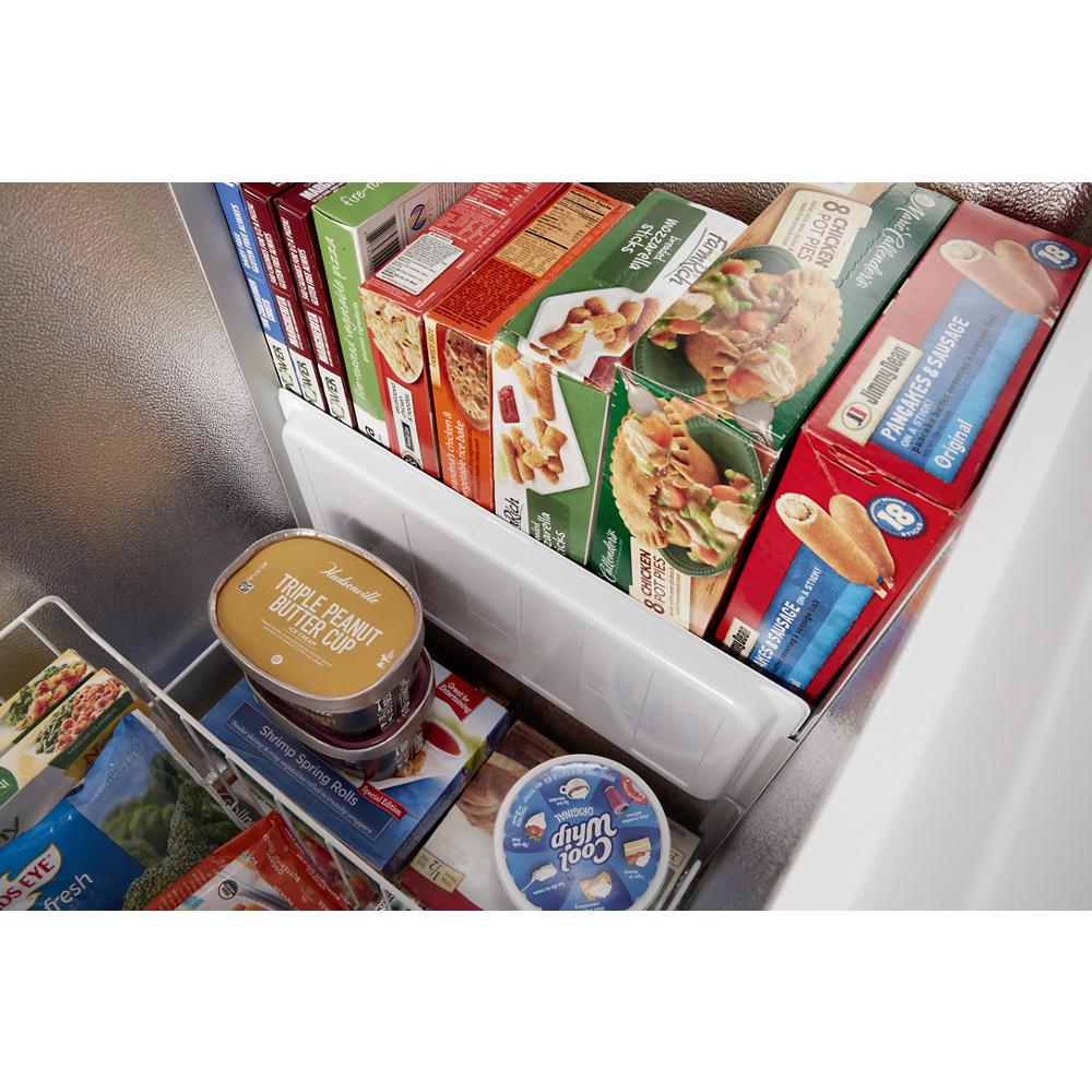 Interior view of chest freezer with organized frozen food boxes and containers in storage bins from Freezers collection