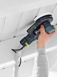 Handheld power sander using a Festool soft sanding pad for woodworking and home improvement projects