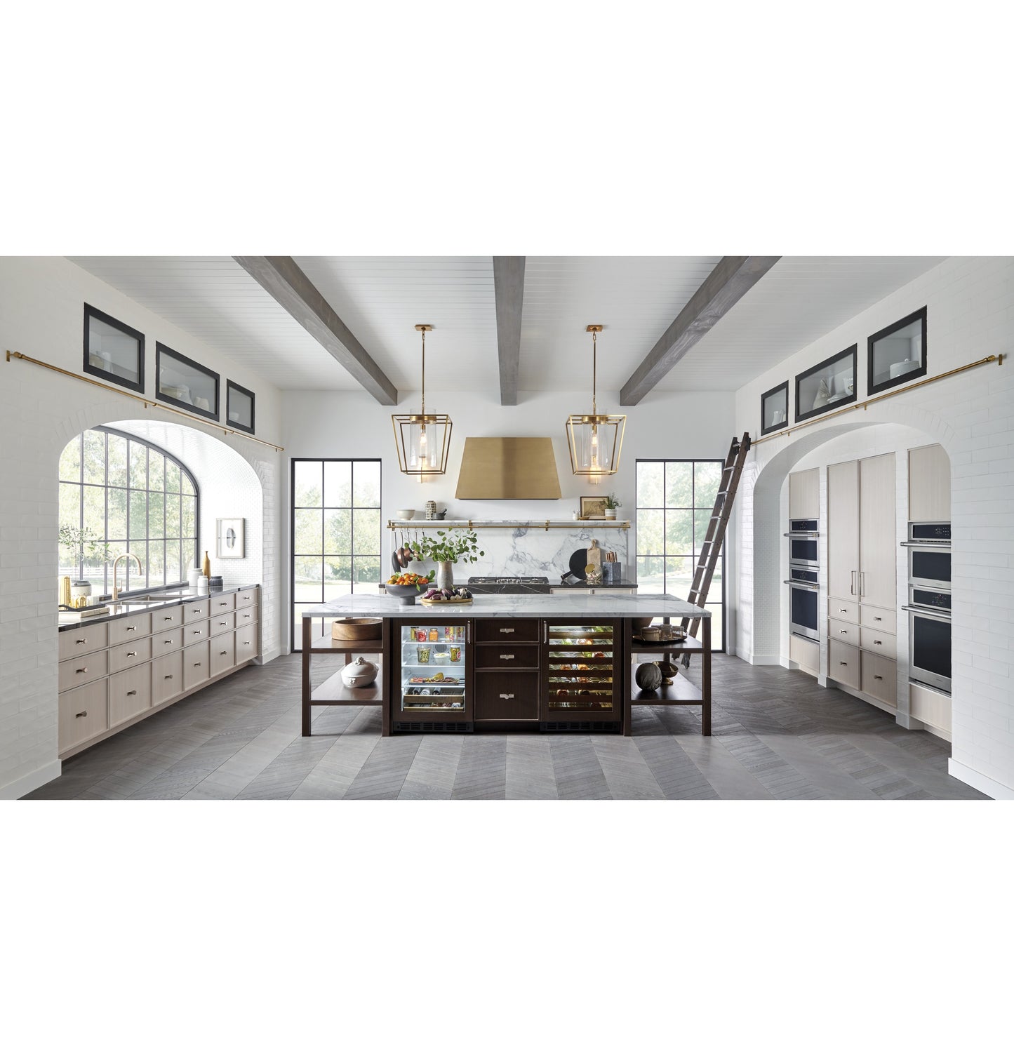 Spacious modern kitchen with built-in appliances, marble island, and natural light from tall windows in kitchen & appliances collection