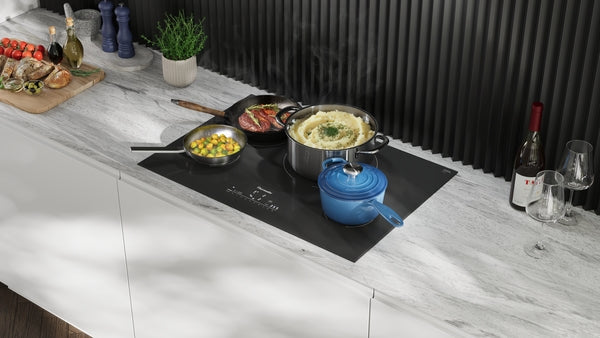 Sleek induction cooktop with cookware on modern kitchen countertop, featuring black backsplash and white cabinetry