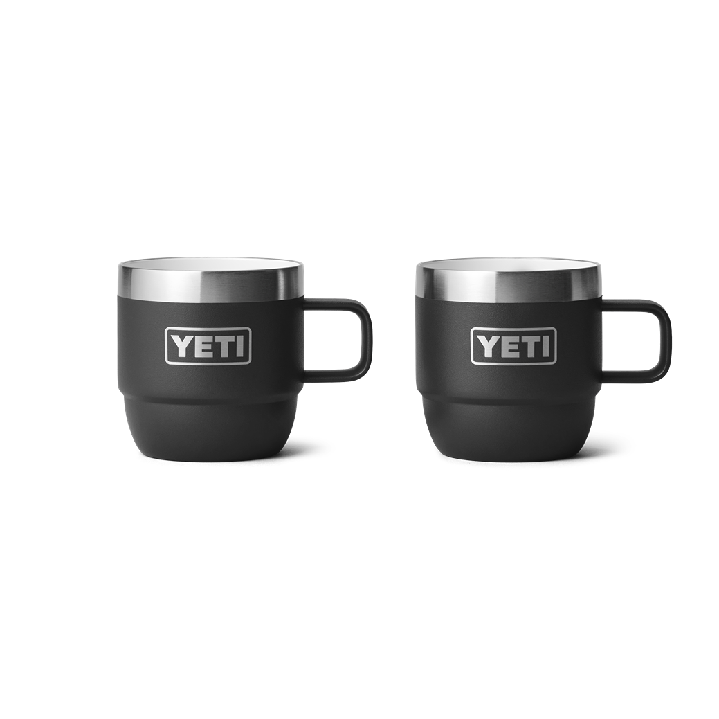 Two black stackable mugs with stainless steel rims designed for durable use in drinkware and kitchen collections