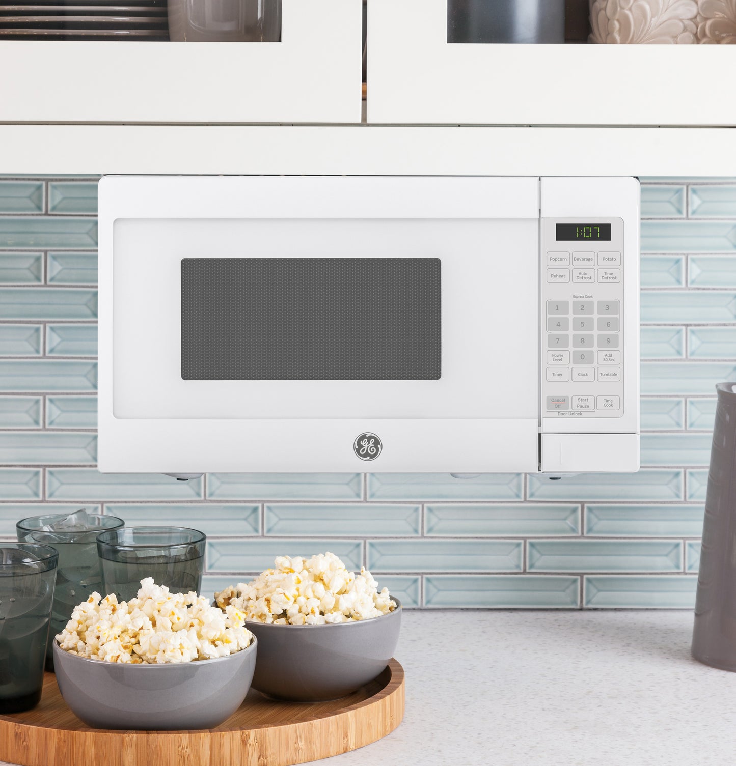 White countertop microwave with keypad controls and digital display in kitchen appliances and countertop microwaves collection