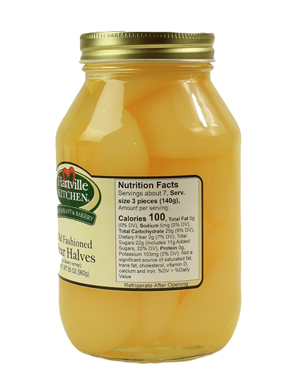 Glass jar of pear halves in syrup with metal lid and Hartville Kitchen label showing nutrition facts panel