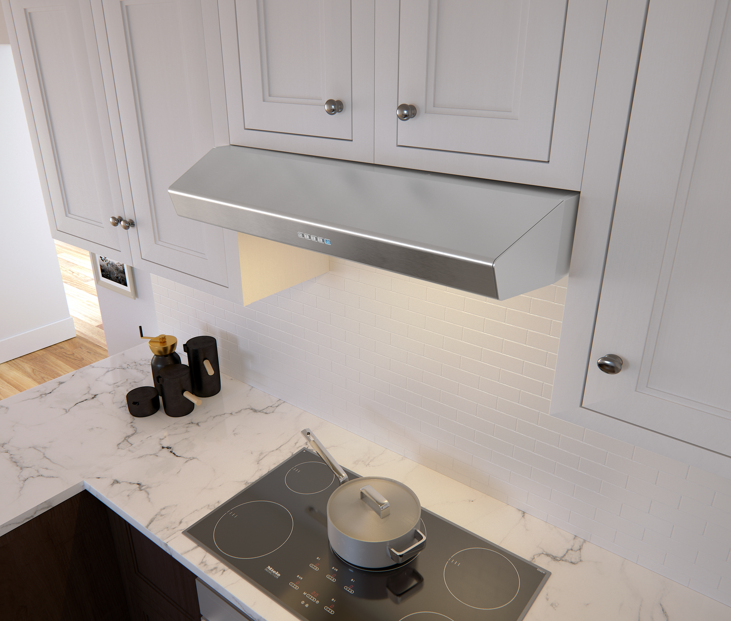 Stainless steel under cabinet range hood with LED lighting above electric cooktop in modern kitchen setting