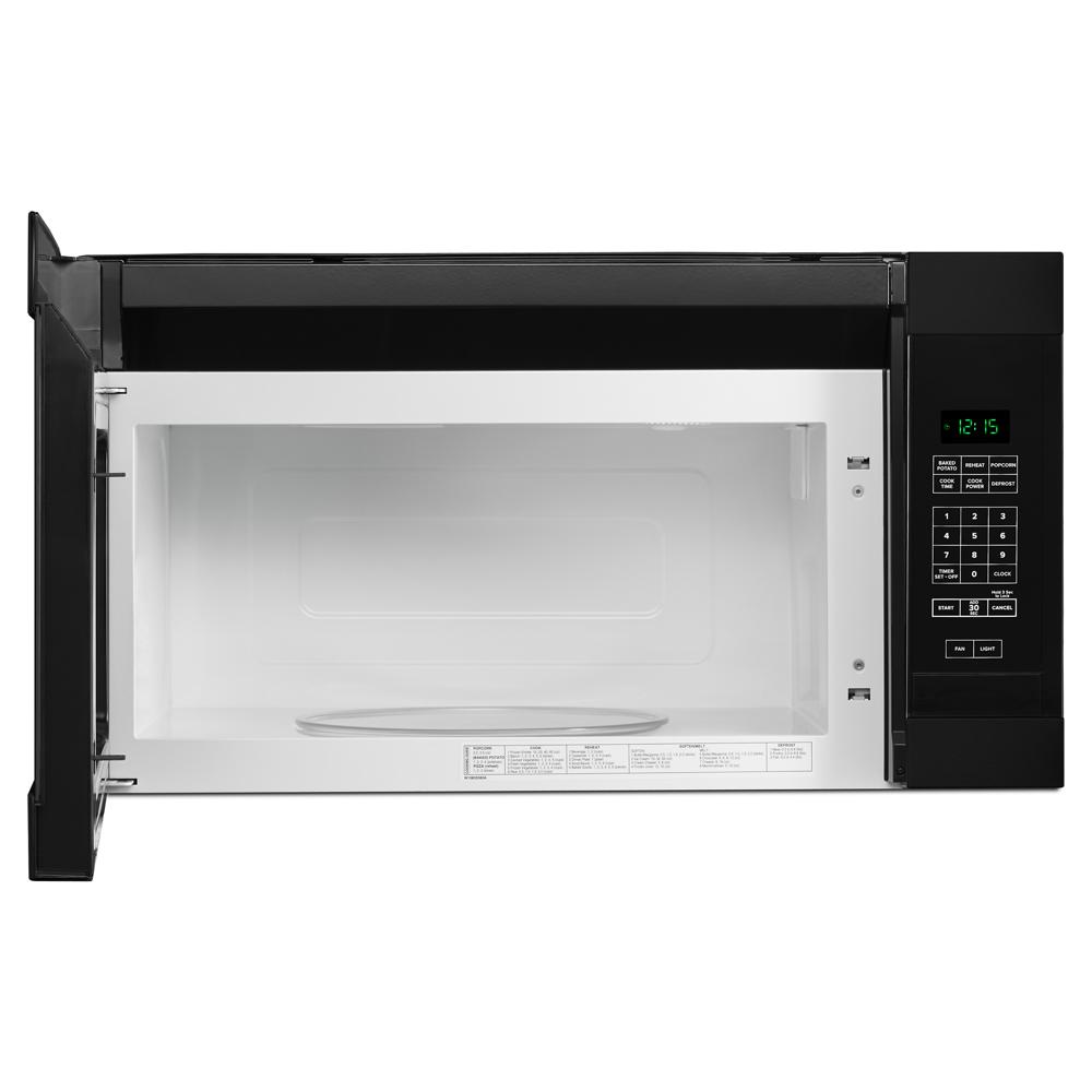 Open black and stainless steel over-the-range microwave interior with digital control panel and turntable in kitchen appliances setting