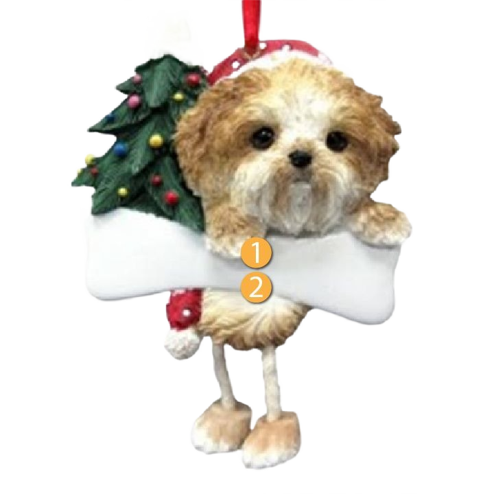 Tan Shih Tzu dog ornament with dangling legs holding a white bone and decorated Christmas tree background