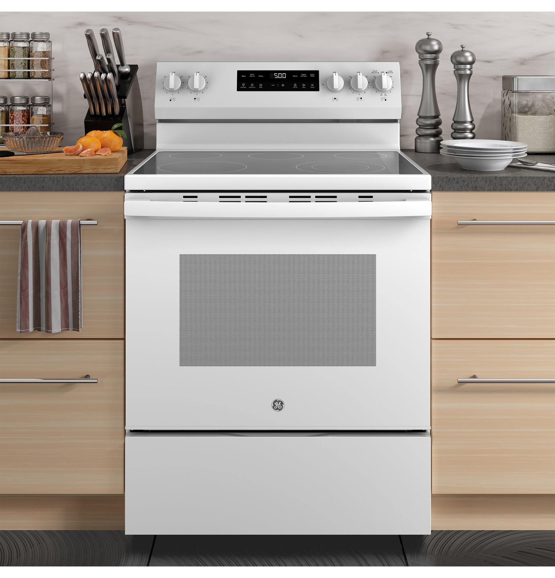 White free-standing electric range with smooth cooktop, rotary knobs, and digital display in a modern kitchen setup