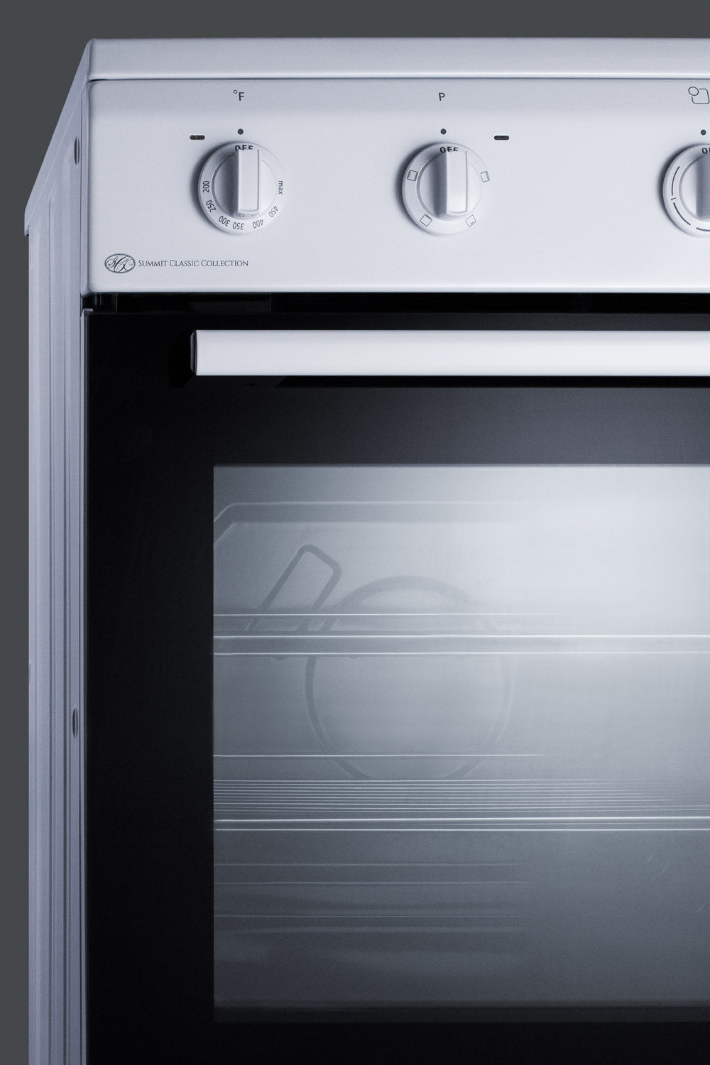 Close-up of white electric range with control knobs and black glass oven door from a classic kitchen appliance collection