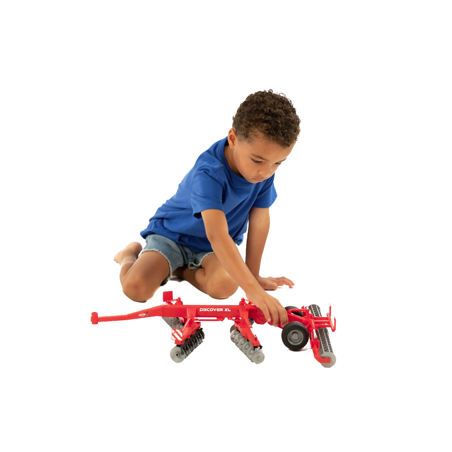 Child playing with red Bruder Kuhn Disc Harrow Discover XL toy from Vehicles & Remote Controlled Toys collection
