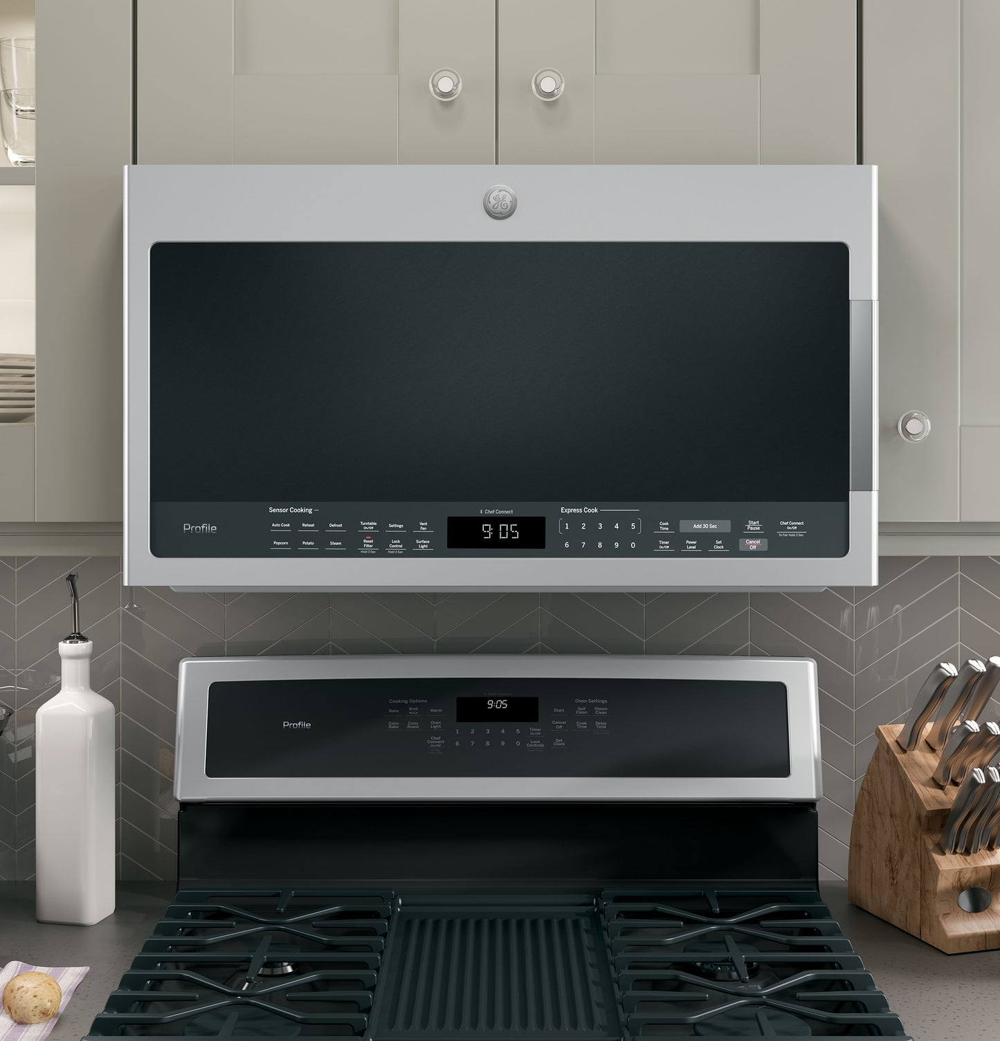 Stainless steel over-the-range sensor microwave with digital control panel in modern kitchen appliances collection