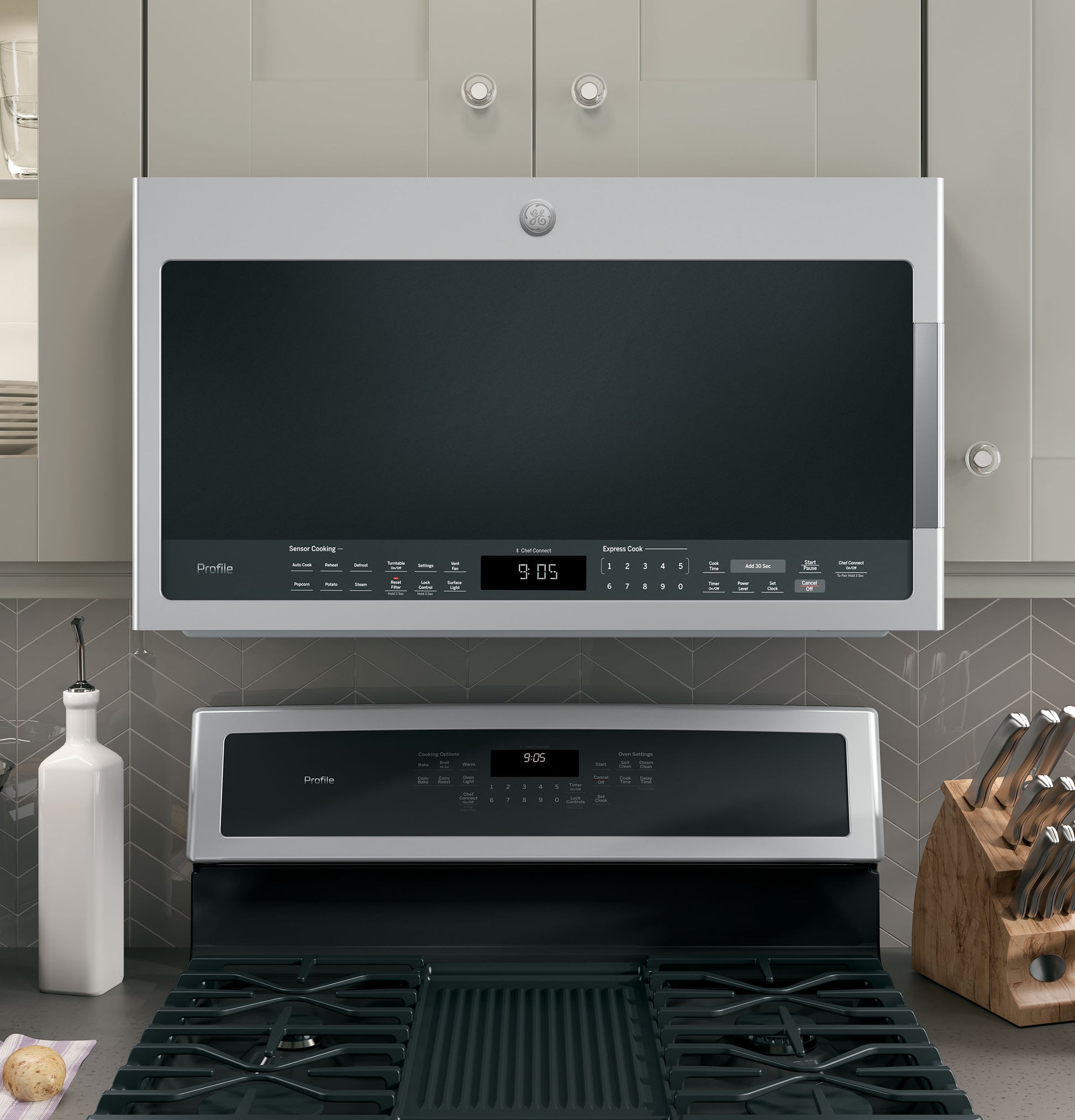 Stainless steel over-the-range sensor microwave with digital control panel in modern kitchen appliances collection