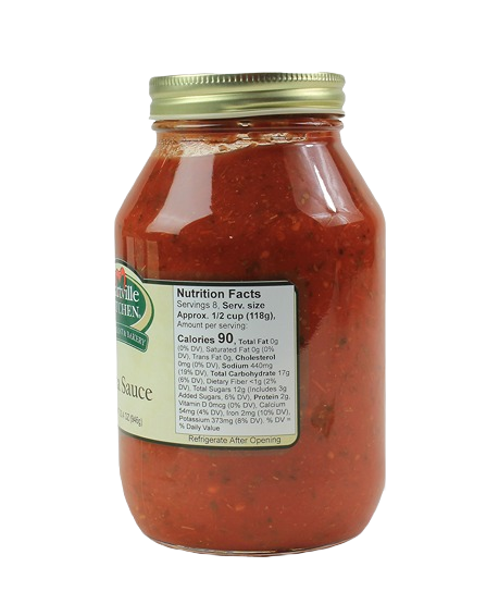 Glass jar of Hartville Kitchen pasta sauce with metal lid and nutrition facts label visible on side