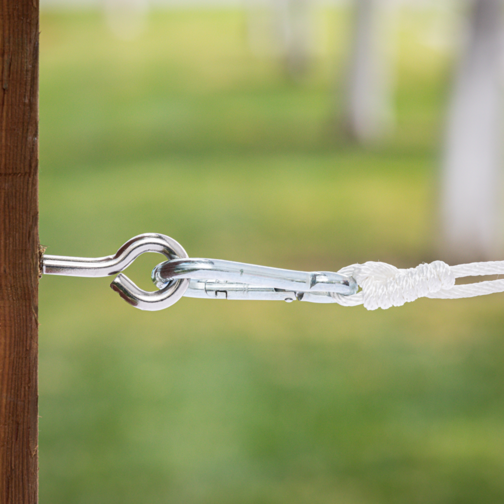 Stainless steel lag screw eye connected to a metal clip and white rope for fastening in hardware and home improvement tools under $50 collection