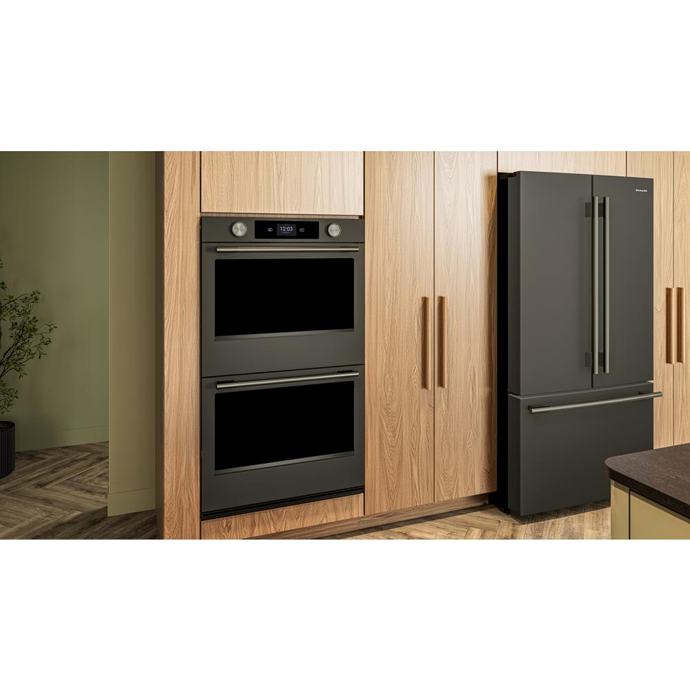 Built-in 30-inch black ore electric double wall oven with digital controls and backlit knobs in modern kitchen setting