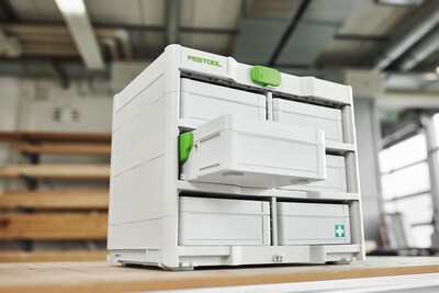 White and green modular Festool SYS3-RACK storage unit with drawers for efficient workshop and jobsite tool organization