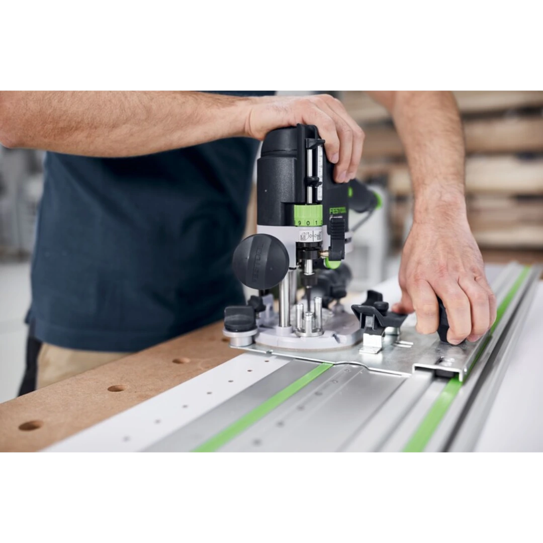 Person adjusting a Festool guide plate on a track system for precise woodworking and home improvement tasks