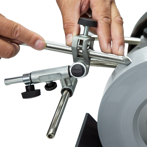Hands adjusting a metal gouge jig tool for sharpening on a grinding wheel for tools and home improvement tasks