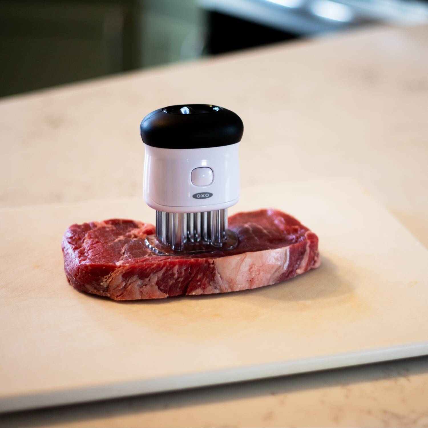 OXO Good Grips bladed meat tenderizer with sharp blades on raw steak for kitchen utensils and cooking tools collections