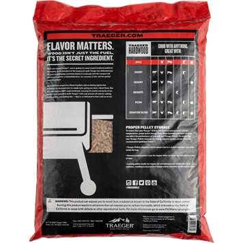 Red and black bag of Traeger apple hardwood pellets with grilling flavor guide and storage instructions on back label
