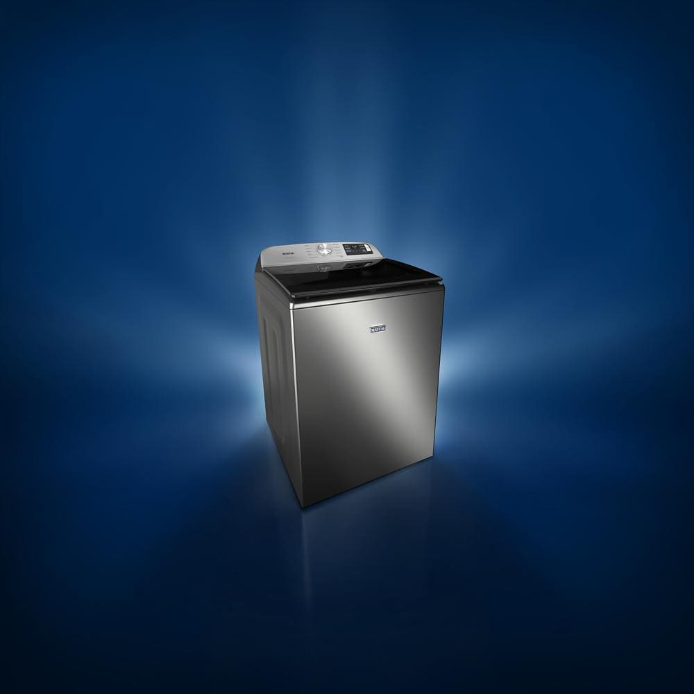 Stainless steel top load washer with digital controls, set against a blue gradient background in appliance collection