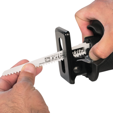 Hand inserting a Makita branded saw blade into a cordless reciprocating saw from the woodworking tools collection