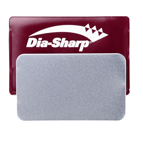 Rectangular fine grit sharpening stone with maroon plastic case for tools and home improvement use