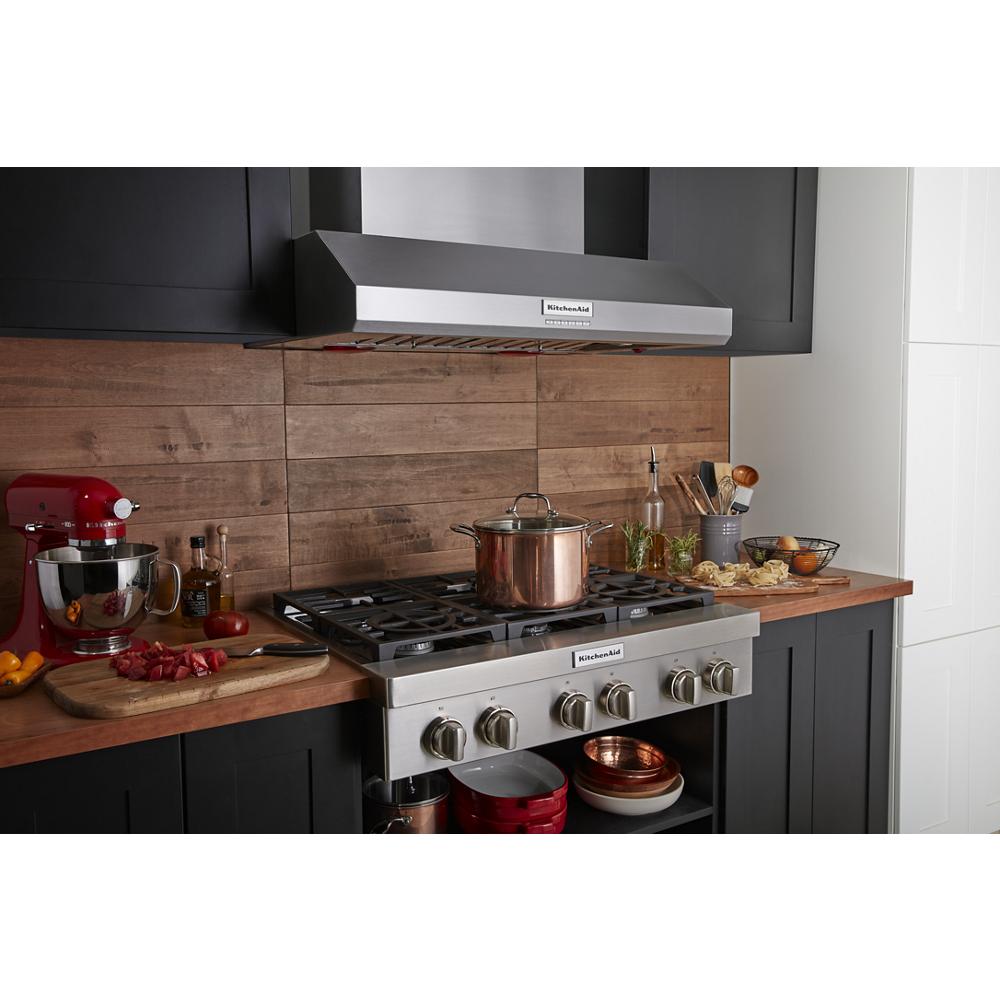 KitchenAid stainless steel 6-burner commercial-style gas rangetop with copper pot and wooden countertop in modern kitchenware collection