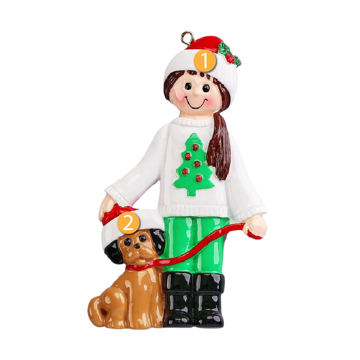 Brunette girl ornament in white sweater with Christmas tree and green pants, holding dog with Santa hat, festive décor under 50 dollars
