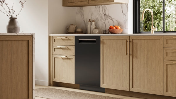 Built-in black dishwasher integrated into modern wood kitchen cabinetry with marble backsplash from Bosch collection