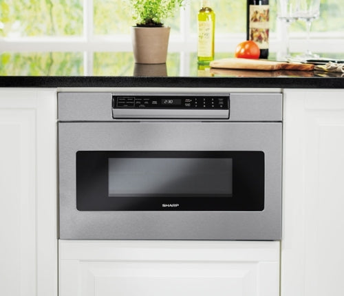 Built-in stainless steel microwave drawer with digital control panel in modern kitchen appliances collection