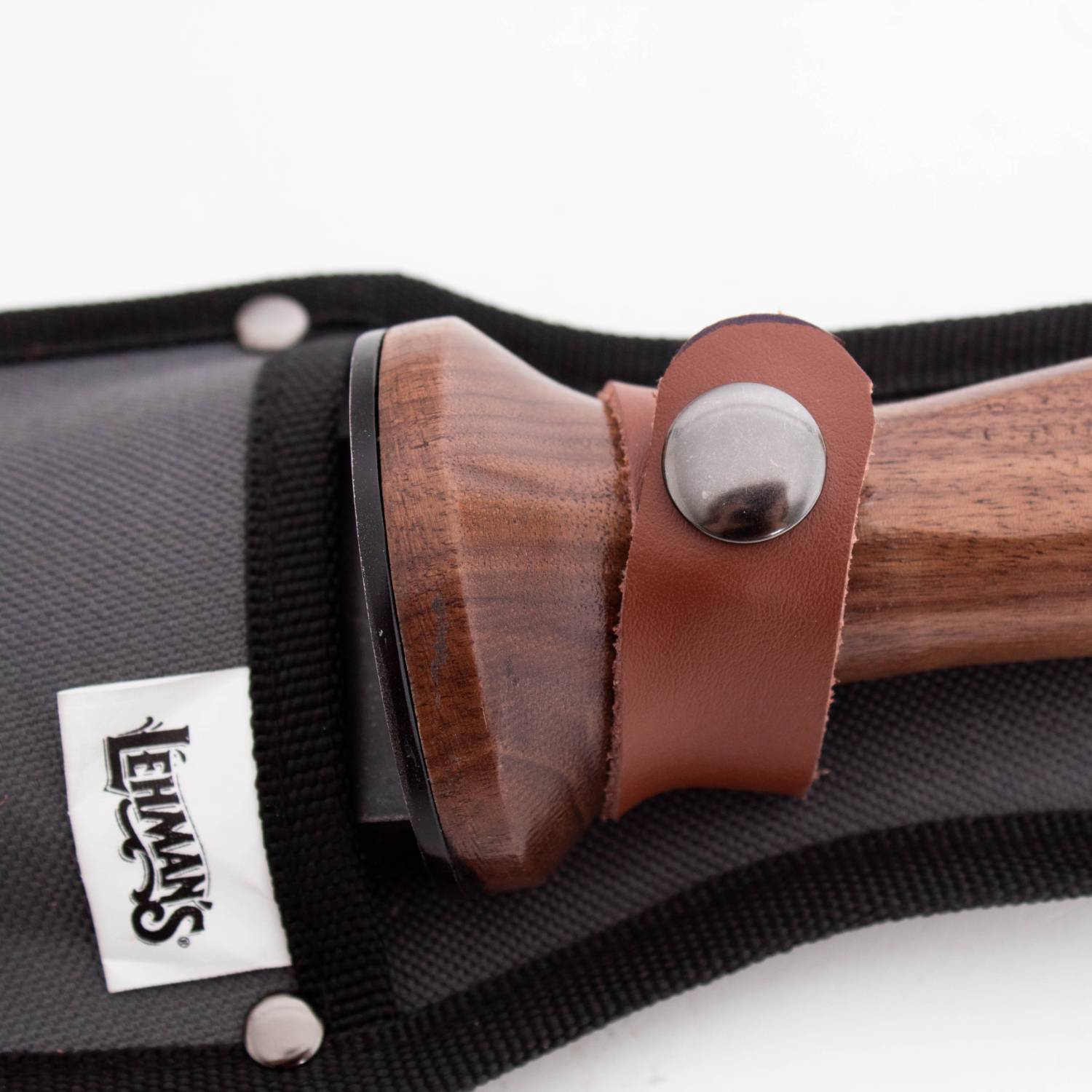 Close-up of wooden handle with leather strap and metal snap on protective sheath for garden and outdoor hand tools collection