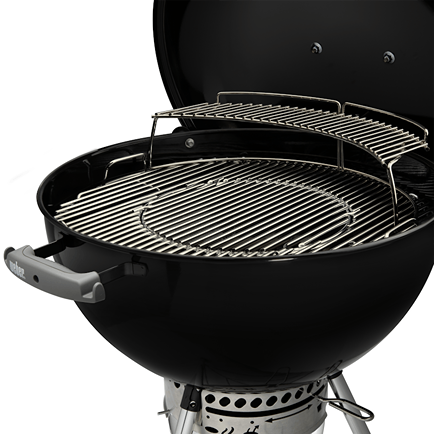 Black charcoal grill with dual-tier stainless steel cooking grates for outdoor living and charcoal grilling enthusiasts