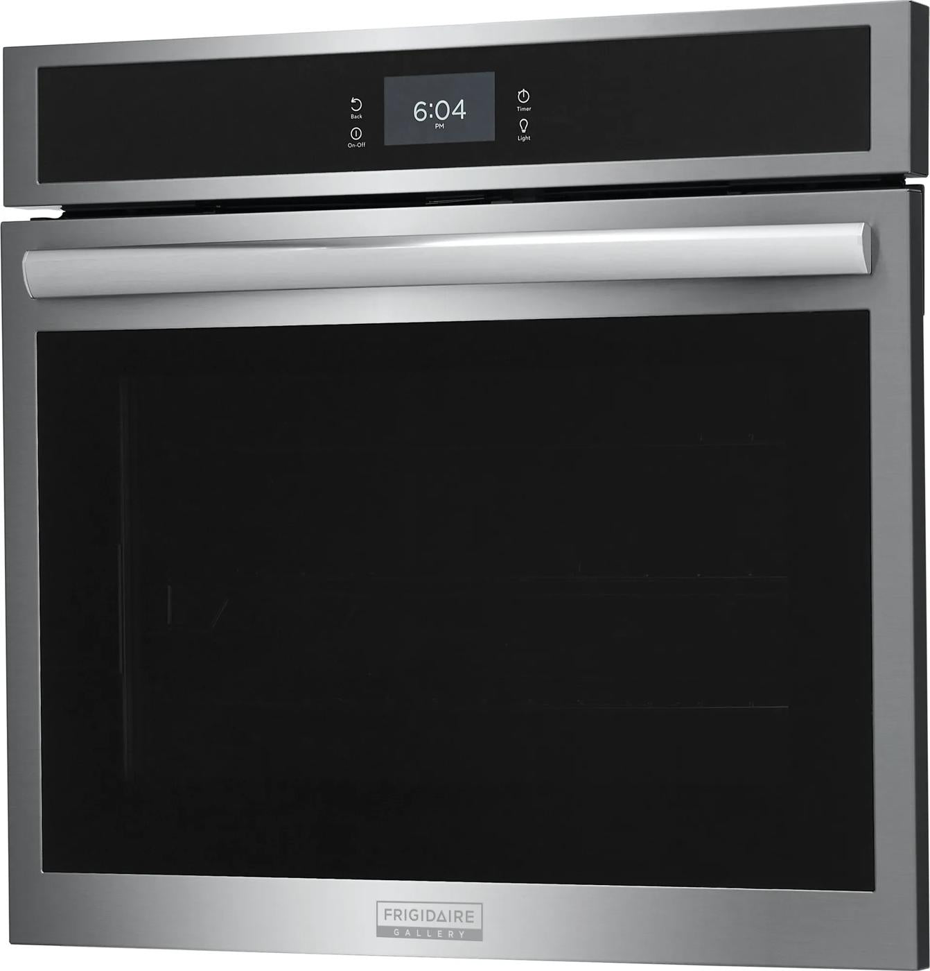 Stainless steel electric wall oven with digital display, large glass window, and curved handle in kitchen setting