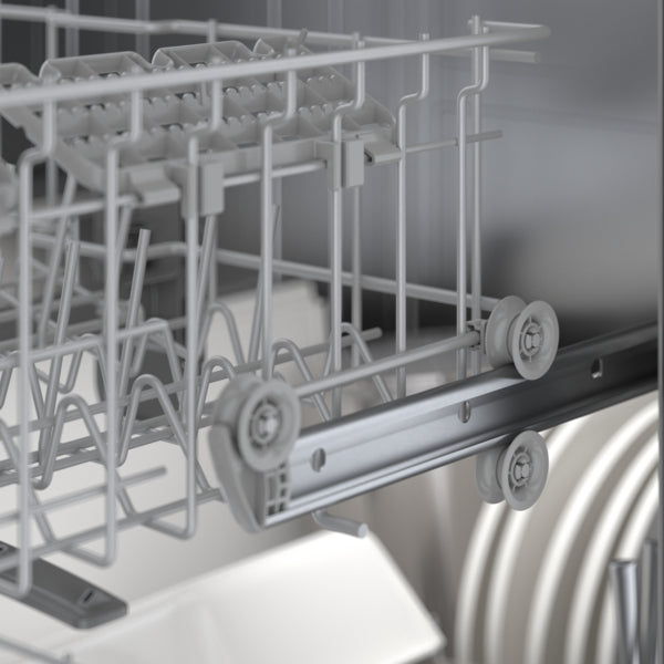 Close-up of upper dishwasher rack with gray metal rails and wheels in a 24-inch white Bosch kitchen appliance