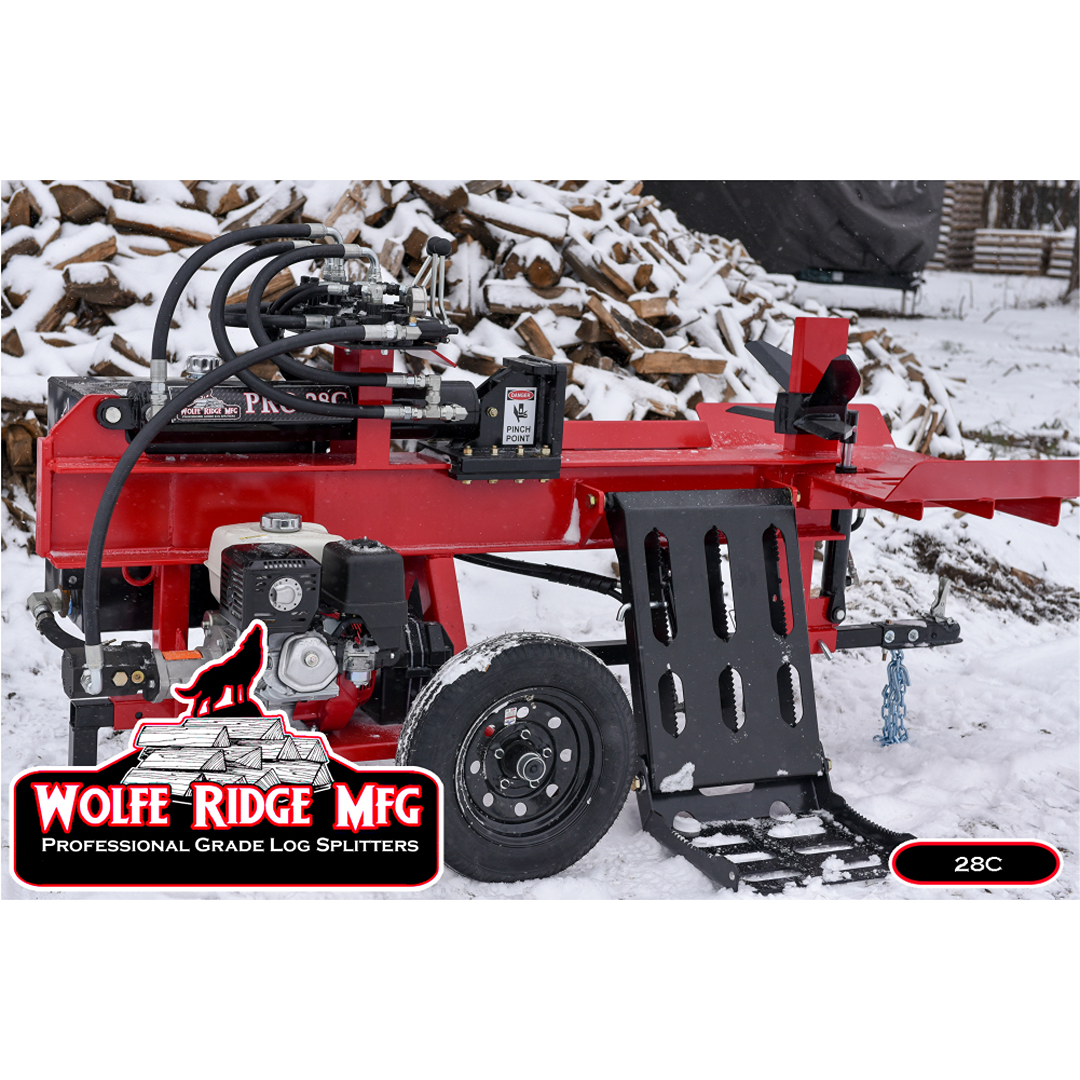 Red compact commercial log splitter with hydraulic system and engine mounted on snowy ground near firewood pile outdoors