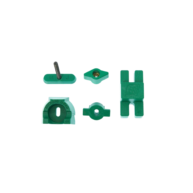 Green plastic replacement clamp pads and hardware pieces designed for tool accessories in home improvement tasks