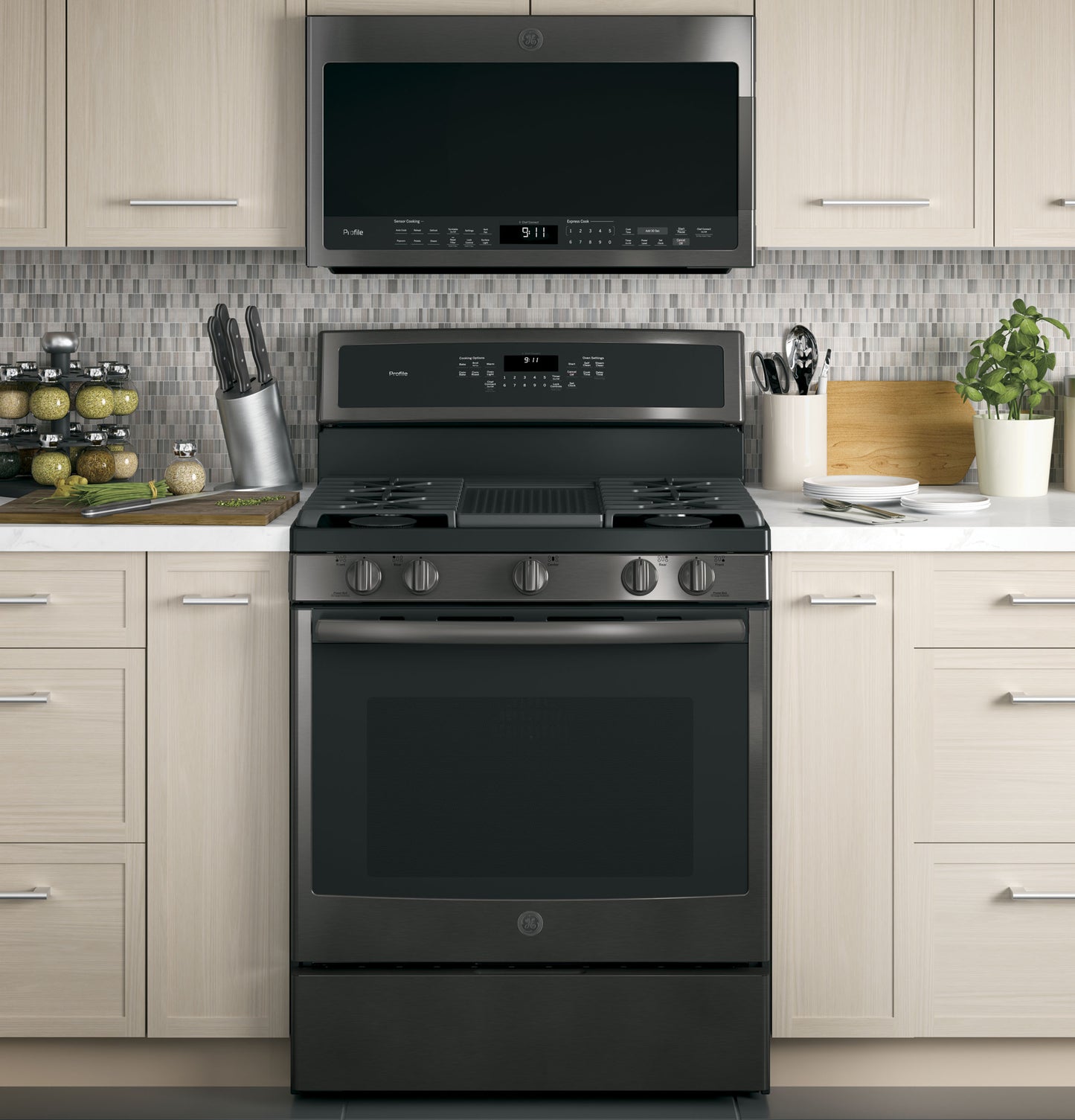 Black stainless steel over-the-range sensor microwave above matching gas range in modern kitchen setup from Microwaves collection