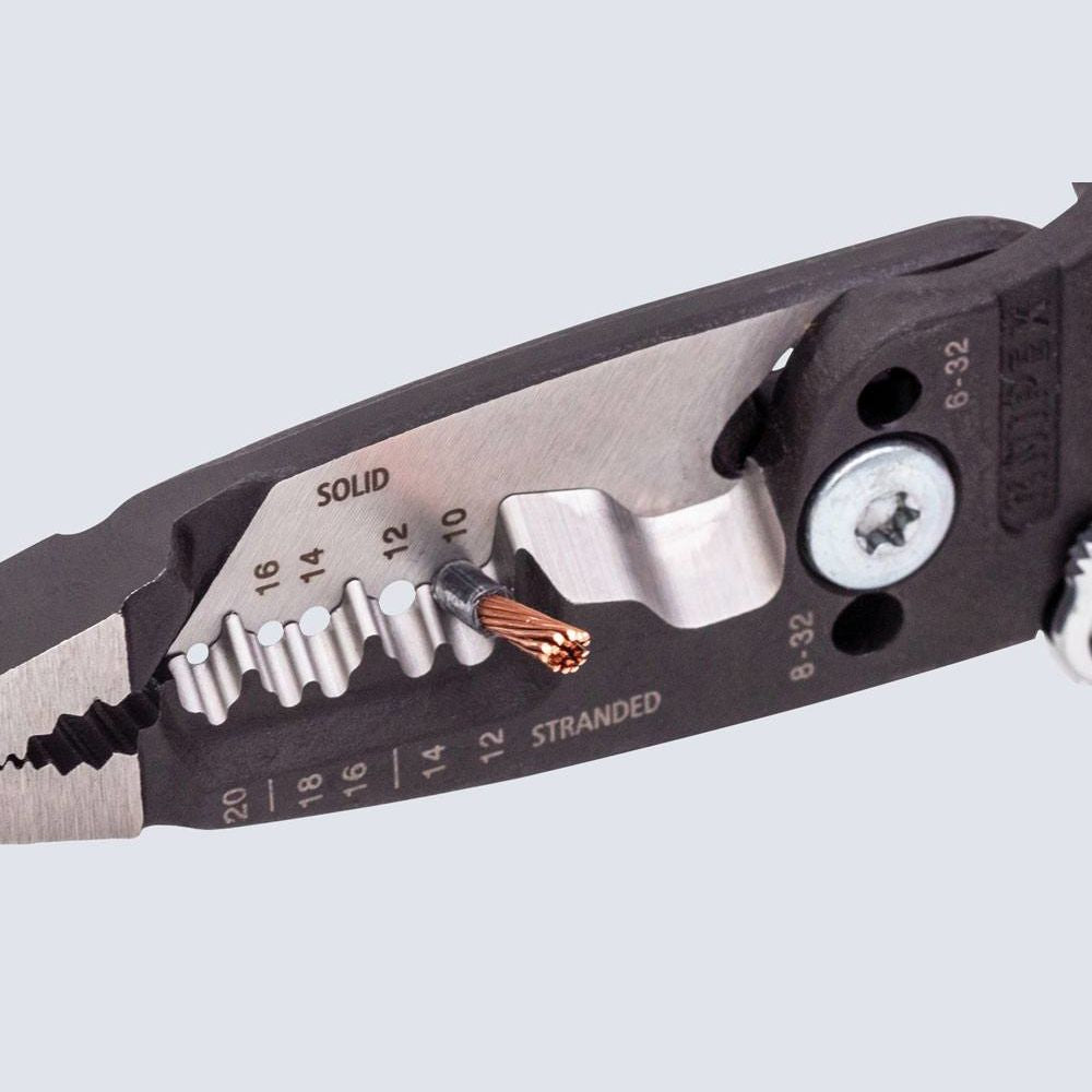 Close-up of forged wire strippers stripping a copper wire with black and metal design for precise home improvement tasks