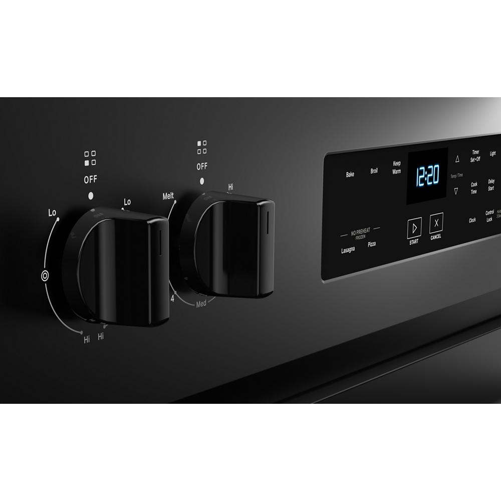 close-up of black electric range control knobs and digital display with timer for kitchen appliances and home improvement