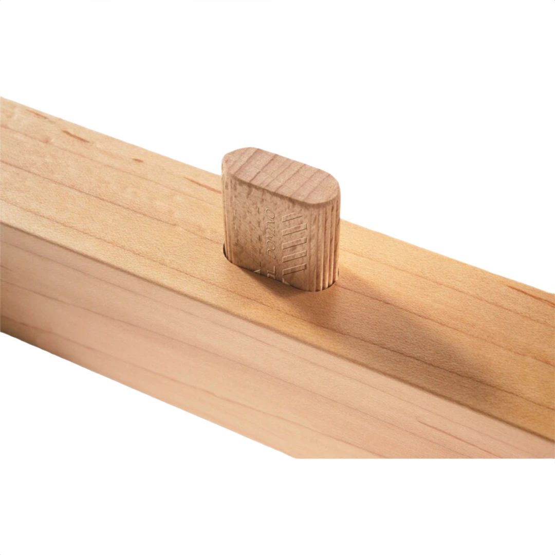 Beech wood domino tenon inserted vertically into a light wood mortise joint for woodworking assembly projects