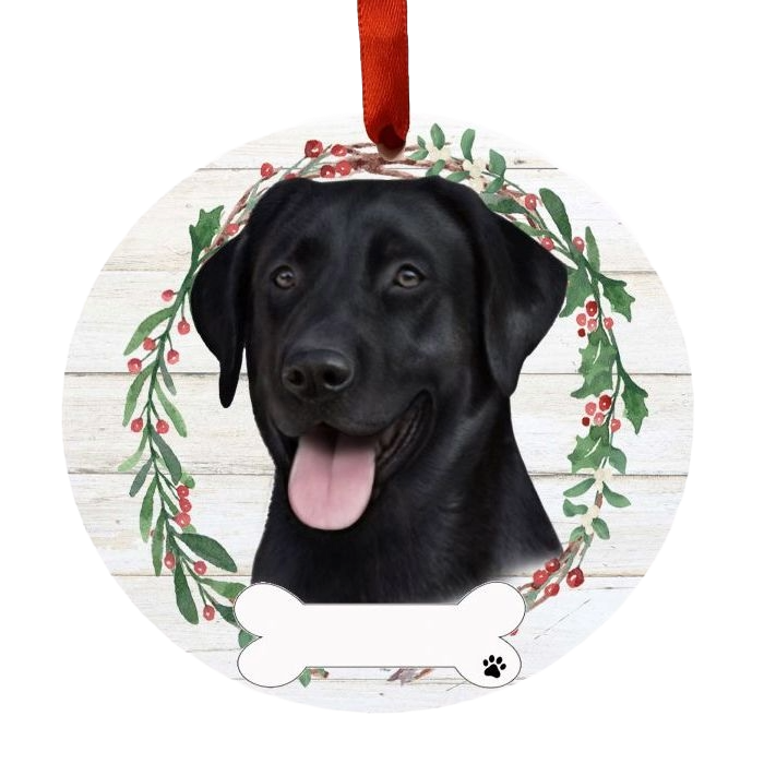 Round Christmas ornament with a black Labrador's face inside a festive berry wreath and red ribbon hanger