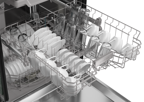 Open stainless steel dishwasher third rack loaded with glasses, mugs, and small plates from kitchenware collection