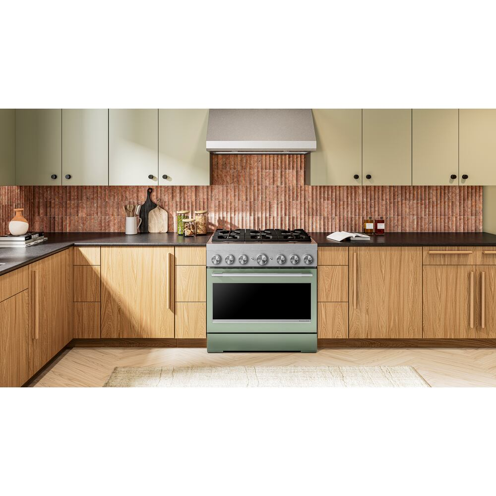 Kitchen with green 36-inch dual fuel range centered between wood lower cabinets and cream upper cabinetry in modern kitchenware setting