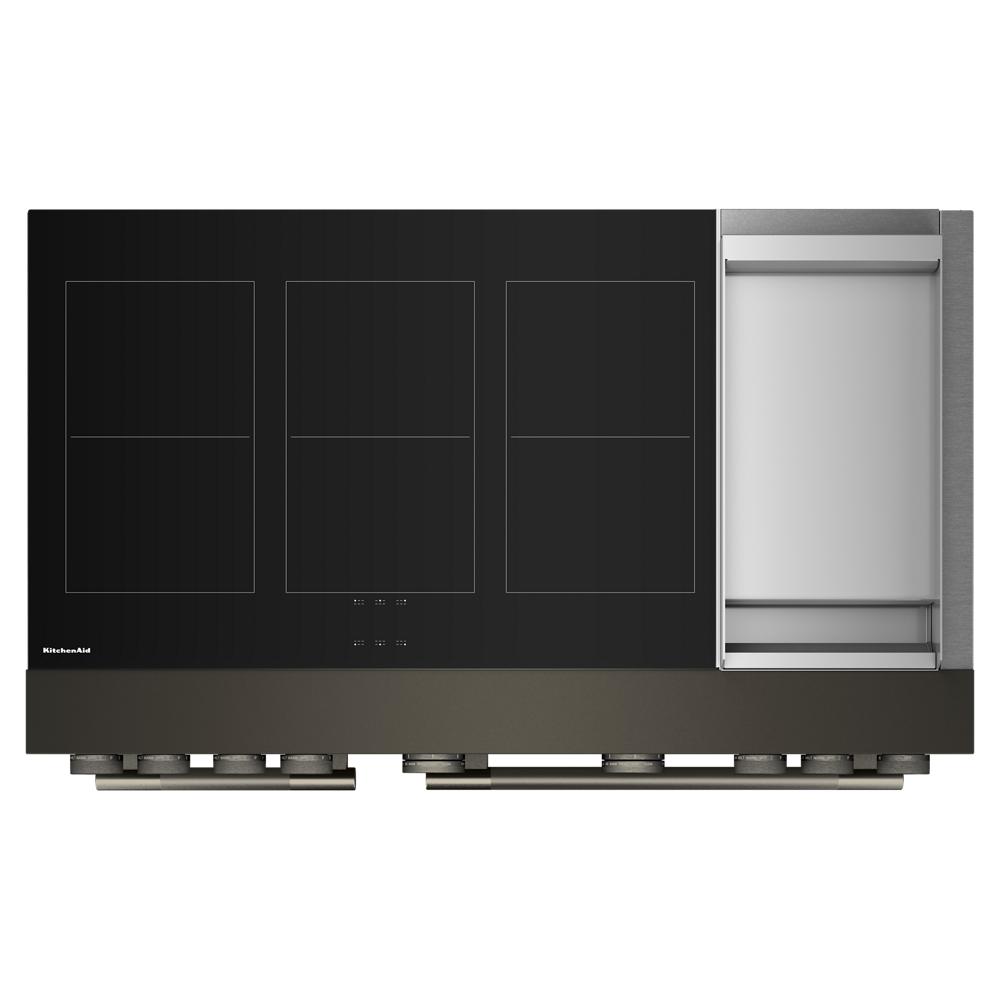 top view of a black induction cooktop with six elements and an integrated stainless steel griddle for kitchenware and home improvement