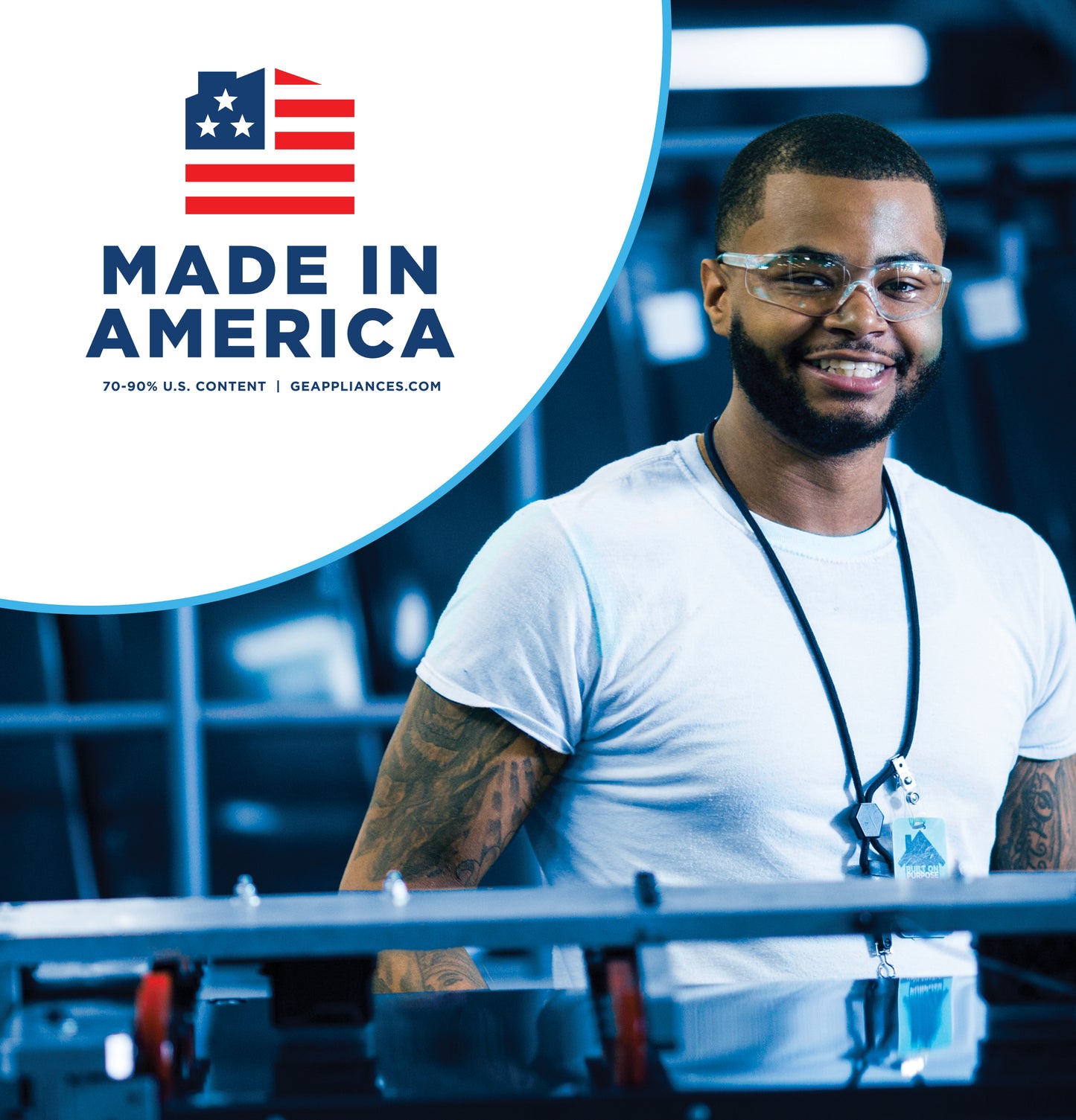 Man wearing safety glasses and badge standing in manufacturing facility with Made in America logo above