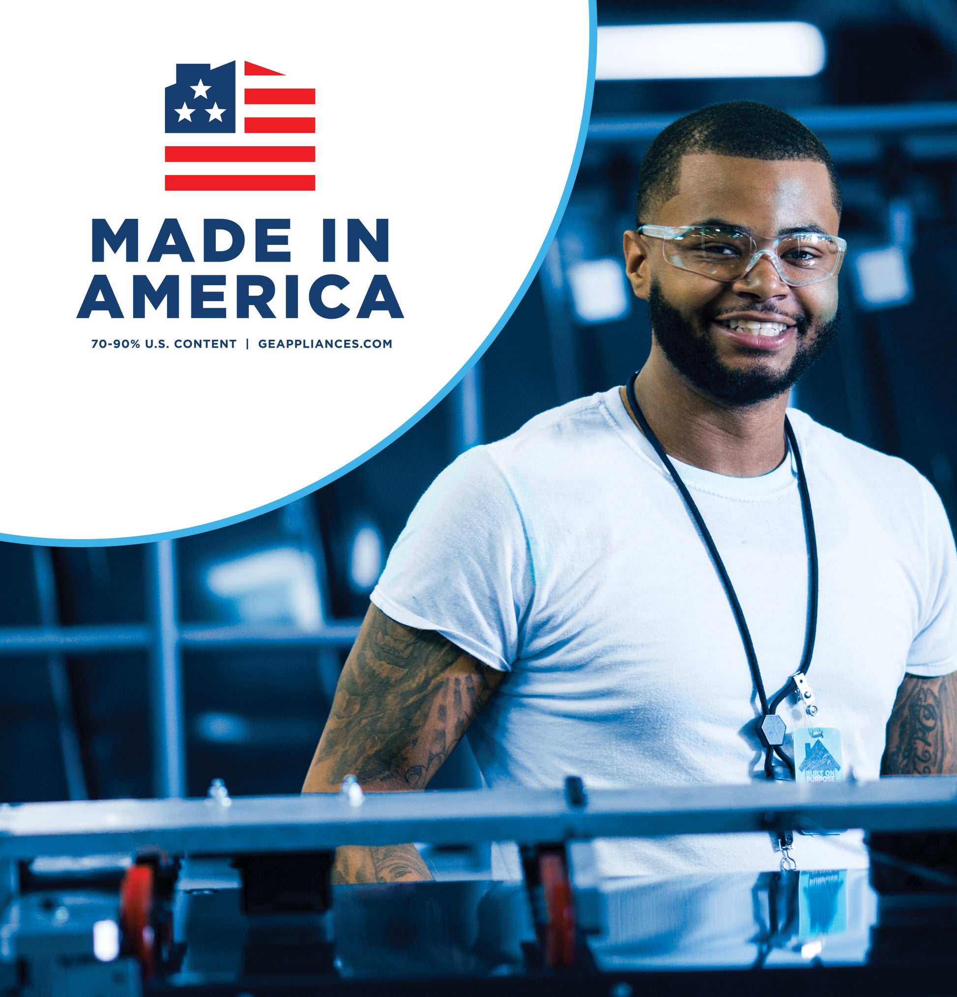 Man wearing safety glasses and badge standing in manufacturing facility with Made in America logo above