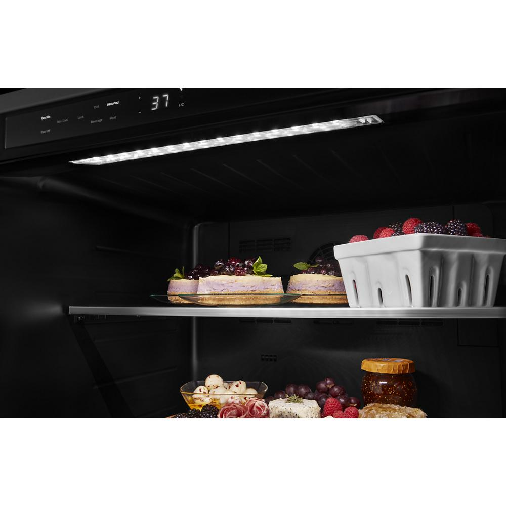 Interior view of Refrigerator with adjustable shelves, LED lighting, and desserts in KitchenAid appliances collection