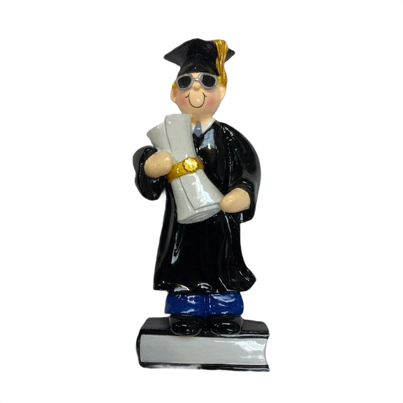 Blonde-haired male graduate ornament in cap and gown holding diploma standing on a book in Christmas collection