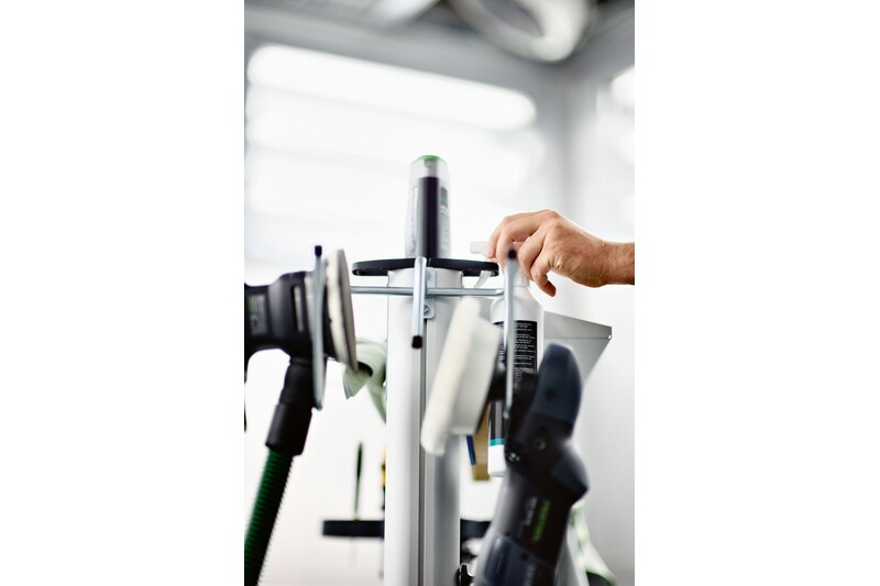 Hand placing a tool on a Festool WCR 1000 WH Hook for Tool in a workshop tool storage setup
